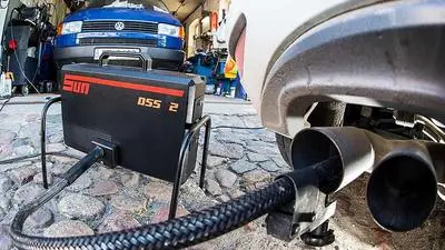 (FILES) This file photo taken on October 1, 2015 in a car workshop in Frankfurt an der Oder, eastern Germany, shows a measuring tube sticking in the exhaust pipe of a Volkswagen Golf 2,0 TDI car during an emissions test.
German car giant Volkswagen is the target of 1,400 legal cases from investors claiming a total of 8.2 billion euros in compensation over its emissions cheating scandal, the state court in Brunswick said in a statement on September 21, 2016. / AFP PHOTO / dpa / Patrick Pleul / Germany OUT