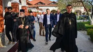 Presidential candidate George Simion (C) walks along with Orthodox-Cristian priests at Pantocrator monastery in the Draganesti-Vlasca village south-west of the Capital city, Romania, on May 1, 2025. Campaigning on a promise to put Romania first, nationalist-sovereignist presidential front-runner George Simion, a fan of US President Donald Trump, says he hopes to turn last year's "stolen" election into a victory by winning Sunday's re-run, channelling simmering frustration over its cancellation. Boasting a direct line to Washington and banking on its support, the leader of the nationalist AUR party has emerged as the favourite to win Sunday's first round. (Photo by Daniel MIHAILESCU / AFP)