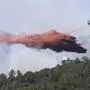 FILE - In this file photo dated Wednesday, July 26, 2017, a firefighting plane drops fire retardant over a forest near La Londe-les-Maures on the French Riviera, after authorities ordered the evacuation of 10,000 people as fires hopscotched around the Riviera for a third day.  Forest blazes are growing in intensity, especially in southern European countries and the European Union describes wildfires as "a serious and increasing threat" across the continent. (AP Photo/Claude Paris, FILE)