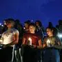 From left, Samuel Lerma, Arzetta Hodges and Desiree Quintanar attend a vigil for victims of the deadly shooting that occurred earlier in the day at a shopping center Saturday, Aug. 3, 2019, in El Paso, Texas. (AP Photo/John Locher)