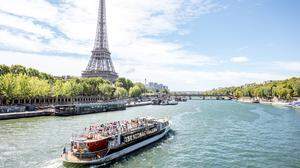Landscpae view on the Eiffel tower and Seine river with tourist boat in Paris