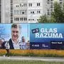 A woman passes by election poster of Prime Minister and President of Croatian Democratic Union (HDZ) party, Andrej Plenkovic (L), reading "For each child, the mother has one year of pensionable service" and election poster of Davor Nadji (R) from "Focus" party reading "Voice of reason", in the centre of Zagreb, on April 16, 2024. Croatia's parliamentary elections are scheduled for April 17, 2024. (Photo by Damir SENCAR / AFP)