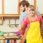 People, housework and housekeeping concept. Couple doing the washing up together in kitchen interior