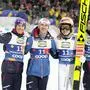 Stefan Kraft, Daniel Tschofenig, Jan Hoerl, and Maximilian Ortnerfrom left, of Austria, pose after winning the silver medal in the ski jumping men's team large hill competition at the Nordic World Ski Championships in Trondheim, Norway, Thursday, March 6, 2025. (AP Photo/Matthias Schrader)