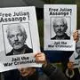 Demonstrators hold placards calling for WikiLeaks founder Julian Assange to be freed and not extradited to the US outside Westminster Magistrates Court in London on October 21, 2019 ahead of a case management hearing in Assange's case. - WikiLeaks founder Julian Assange was ordered Friday to make his first in-person London court appearance to determine whether he can be released from prison as he fights extradition to the United States. The 48-year-old Australian has been in custody at the high-security Belmarsh prison in southwest London since being dramatically dragged from Ecuador's embassy in April. (Photo by DANIEL LEAL-OLIVAS / AFP)