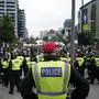 Police officers block a road near the stadium after a group people tried to get into the ground without tickets ahead of the Champions League final soccer match between Borussia Dortmund and Real Madrid at Wembley stadium in London, Saturday, June 1, 2024. (AP Photo/Alberto Pezzali)