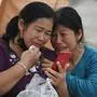 Women react after hearing of the death of a relative at the site of an under-construction building collapse in Bangkok on March 30, 2025, two days after an earthquake struck central Myanmar and Thailand. The death toll from a huge earthquake that hit Myanmar and Thailand passed 1,600, as rescuers dig through the rubble of collapsed buildings in a desperate search for survivors. (Photo by Lillian SUWANRUMPHA / AFP)