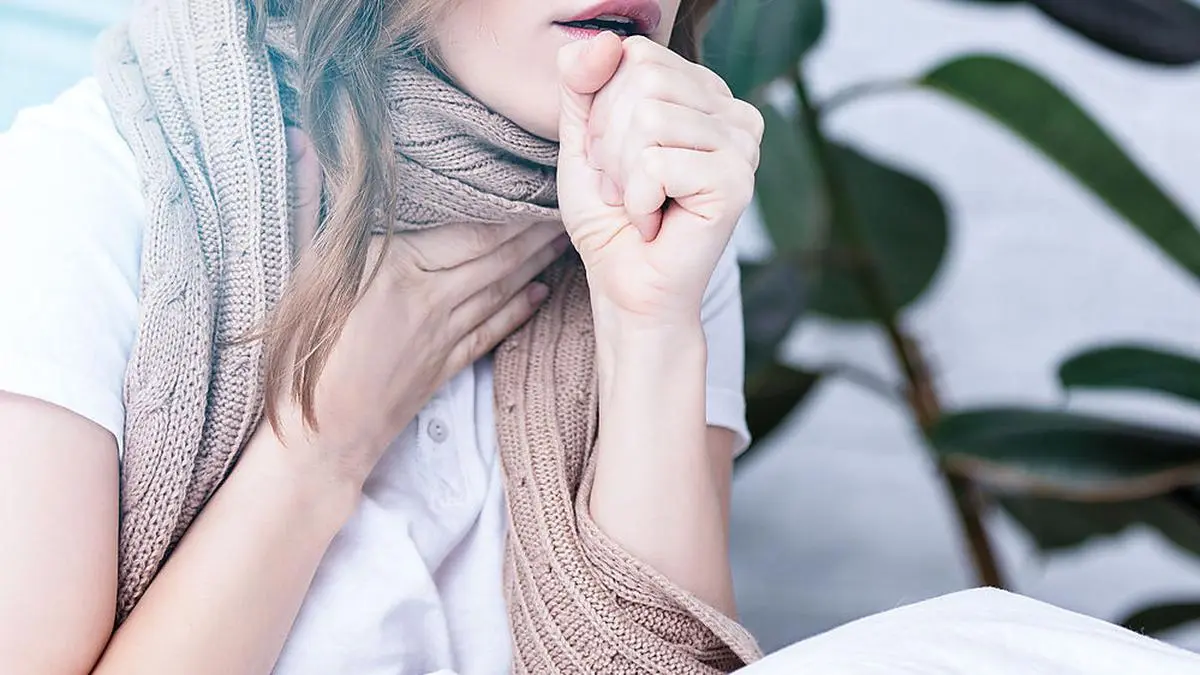 panoramic view of sick woman coughing at home