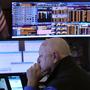 Trader Robert Moran works in his booth on the floor of the New York Stock Exchange, Wednesday, Aug. 7, 2024. (AP Photo/Richard Drew)