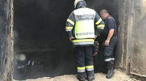 Der Sägespänesilo wird von den Feuerwehrleuten entleert