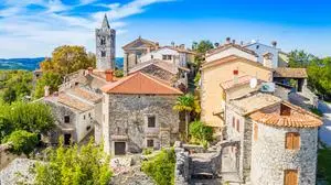 Beautiful  old  town  of  Hum,  stone  houses  and  church  tower  bell,  romantic  traditional  architecture  in  Istria,  Croatia,  aerial  view  from  drone xkwx cobbled,  walkway,  homes,  site,  tourist,  street,  roof,  panorama,  house,  aerial,  ancient,  architecture,  building,  church,  city,  cityscape,  croatia,  croatian,  decoration,  drone,  europe,  european,  famous,  green,  heritage,  high,  hill,  historic,  historical,  history,  hum,  istra,  istria,  istrian,  landmark,  landscape,  medieval,  mediterranean,  old,  paved,  rural,  scene,  scenic,  stone,  tourism,  town,  traditional,  travel,  village