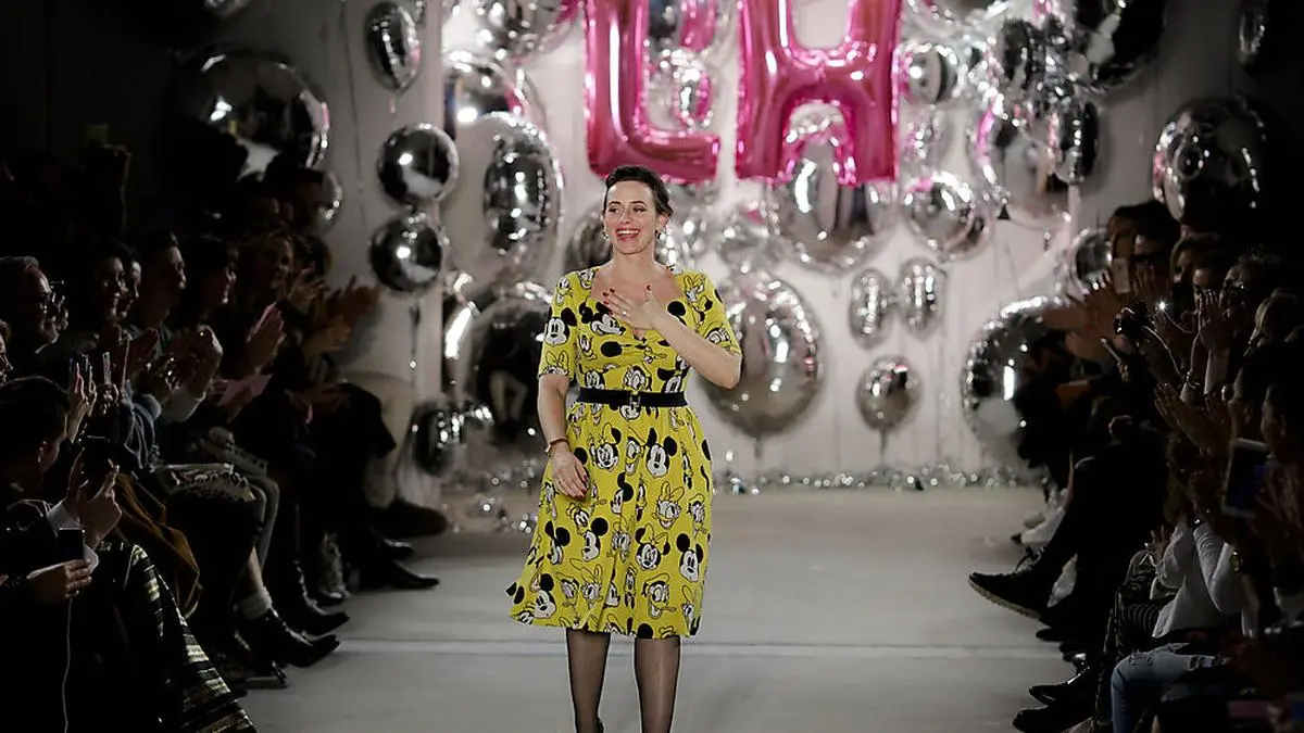 Designer Lena Hoschek accepts the applause from the audience after her fashion show at the Mercedes Benz Fashion Week in Berlin, Tuesday, Jan. 17, 2017. (AP Photo/Markus Schreiber)