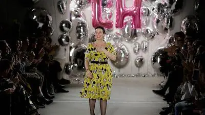 Designer Lena Hoschek accepts the applause from the audience after her fashion show at the Mercedes Benz Fashion Week in Berlin, Tuesday, Jan. 17, 2017. (AP Photo/Markus Schreiber)