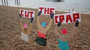 May 18, 2024, Brighton, England, United Kingdom: Three wooden figures hold signs saying     Cut The Crap     during the protest near the West Pier. Surfers Against Sewage SAS and their supporters took to the sea to highlight the amount of sewage pumped into Sussex    s waterways. Many of those taking to the sea in sewage-themed fancy dress said they had become ill while swimming previously. SAS is a marine conservation charity that works with communities to protect oceans, beaches and marine life. Brighton United Kingdom - ZUMAmp3_ 20240518_zip_mp3_014 Copyright: xMartinxPopex