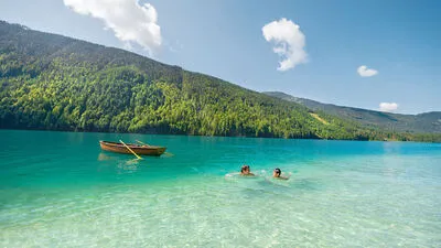 Nadelwald wegretouchieren, Ruderboot gegen Segelboot tauschen – und der Weißensee wird zur Karibik