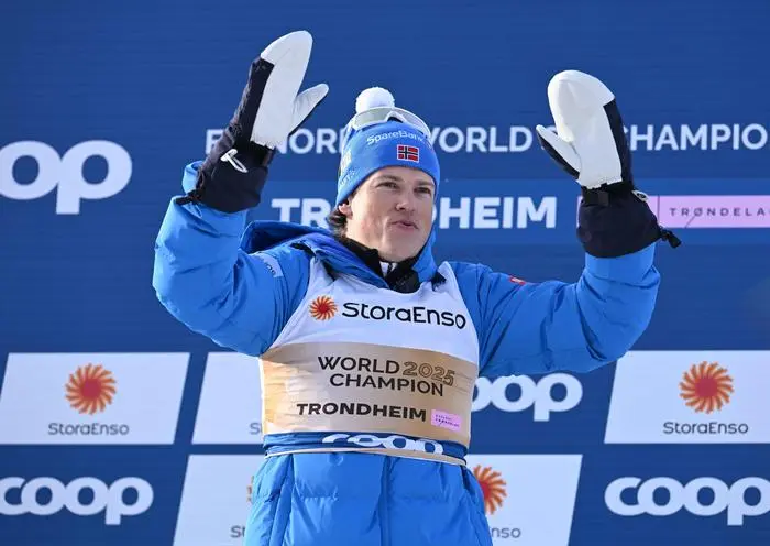 Gold medalist Norway’s Johannes Hoesflot Klaebo celebrates on the podium after the men's 50km Mass Start Free event of the Cross Country discipline at the FIS Nordic World Ski Championships in Trondheim, Norway on March 8, 2025.  (Photo by Jonathan NACKSTRAND / AFP)