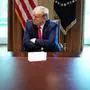 US President Donald Trump speaks during a meeting with patients who have recovered from the novel coronavirus, COVID-19, in the Cabinet Room of the White House in Washington, DC on April 14, 2020. - President Donald Trump's plan to reopen the post-pandemic US economy, starting with the unveiling of a new task force Tuesday, was mired in controversy after he was accused of seeking king-like powers. Facing a tough reelection in November, the Republican president is eager to get the world's biggest economy back on its feet as quickly as possible. (Photo by MANDEL NGAN / AFP)