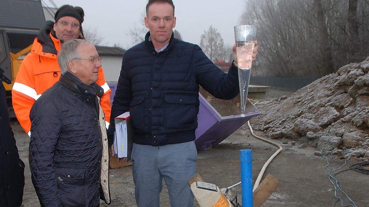 Josef Ober und Brunnenbauer Roland Eder mit Wasser aus dem ersten Pumpversuch