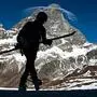 TOPSHOT - A professional skier is silhouetted against the Matterhorn (Cervino) summit in the alpine ski resort of Breuil-Cervinia, Northwestern Italy, on November 25, 2020. - Closed shops, hotels and restaurants: Italy's ski resorts look like dead towns and their hopes of reopening before Christmas are now almost nil, causing concern and disarray, while neighbouring Switzerland has reopened its slopes. (Photo by Marco Bertorello / AFP)