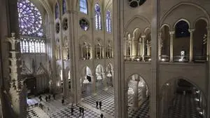 FILE - People stroll in Notre-Dame de Paris cathedral while French President Emmanuel Macron visits the restored interiors the monument, Friday, Nov.29, 2024 in Paris. (Christophe Petit Tesson, Pool via AP, File)