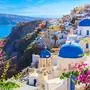 Santorini island, Greece. Oia town traditional white houses and churches with blue domes over the Caldera, Aegean sea.