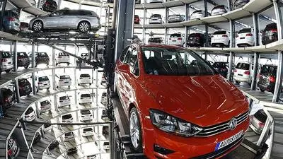 (FILES) This file photo taken on March 10, 2015 shows a VW Golf car (R) inside the so-called car towers of car manufacturer Volkswagen AG (VW) at the company's assembly plant in Wolfsburg, northern Germany.
Embattled automaker Volkswagen will hold talks Monday, August 22, 2016, with two component suppliers, in a bid to end a stand-off over car parts deliveries that has severely disrupted production at the German giant. / AFP PHOTO / TOBIAS SCHWARZ