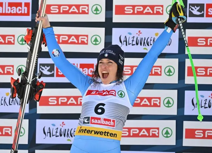 Second placed Italy's Federica Brignone celebrates on the podium after the Women's Super-G event of the Saalbach 2025 FIS Alpine World Ski Championships in Hinterglemm on February 6, 2025. (Photo by KERSTIN JOENSSON / AFP)