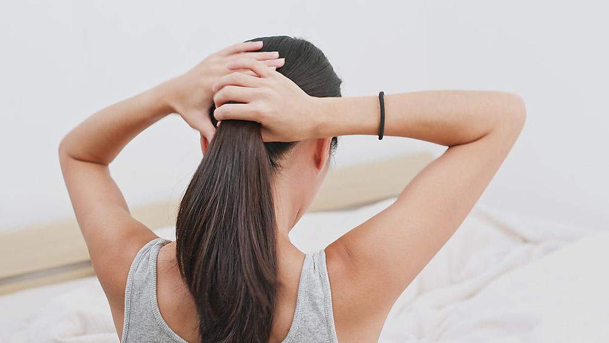 Woman tied her hair at home