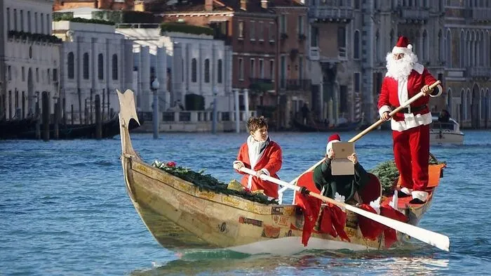 In Venedig fand am Sonntag eine vorweihnachtliche Regatta auf dem Canale Grande statt. Manch Weihnachtsmann hatte in der Gondel sogar seinen Laptop mit.