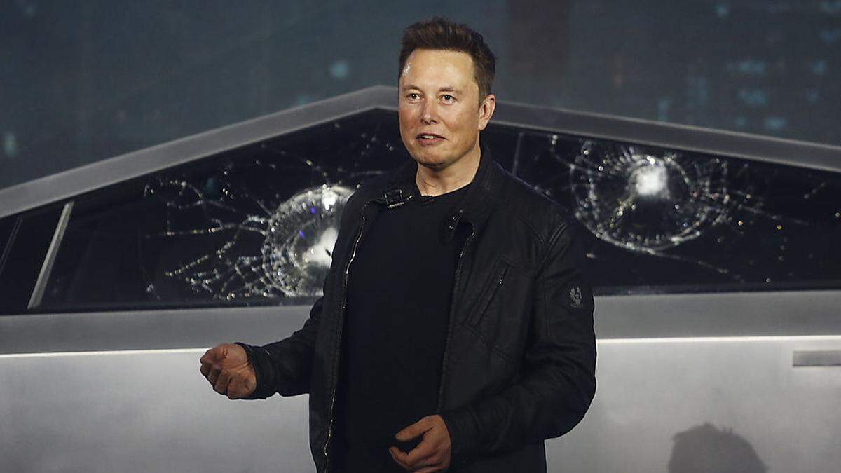 Tesla-Chef Elon Musk musste die Präsentation mit den beschädigten Scheiben im Hintergrund fortsetzen