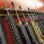 FILE - In this July 20, 2012, photo, a row of different AR-15 style rifles are displayed for sale at the Firing-Line indoor range and gun shop in Aurora, Colo. A warning about possible violence last year involving the 18-year-old now being held in the Buffalo, New York, supermarket shooting is turning attention to New York's "red flag" law. (AP Photo/Alex Brandon, File)