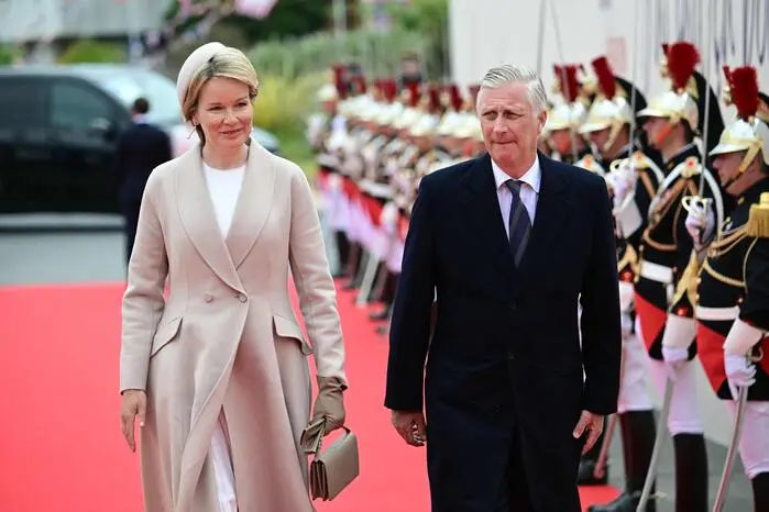 Queen Mathilde of Belgium and King Philippe of Belgium arrive to attend the International commemorative ceremony at Omaha Beach marking the 80th anniversary of the World War II "D-Day" Allied landings in Normandy, in Saint-Laurent-sur-Mer, in northwestern France, on June 6, 2024. The D-Day ceremonies on June 6 this year mark the 80th anniversary since the launch of 'Operation Overlord', a vast military operation by Allied forces in Normandy, which turned the tide of World War II, eventually leading to the liberation of occupied France and the end of the war against Nazi Germany. (Photo by MIGUEL MEDINA / AFP)