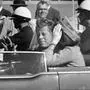 FILE - In this Nov. 22, 1963 file photo, President John F. Kennedy waves from his car in a motorcade in Dallas. Riding with Kennedy are First Lady Jacqueline Kennedy, right, Nellie Connally, second from left, and her husband, Texas Gov. John Connally, far left. The National Archives released the John F. Kennedy assassination files on Thursday, Oct. 26, 2017. (AP Photo/Jim Altgens, File)