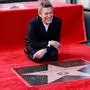 TOPSHOT - US actor Willem Dafoe poses with his newly unveiled Hollywood Walk of Fame star in Hollywood, California, on January 8, 2024. (Photo by Michael Tran / AFP)