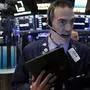 Trader Gregory Rowe works on the floor of the New York Stock Exchange, Tuesday, March 3, 2020. Stocks are opening lower on Wall Street after the Group of Seven countries held off on giving the global economy new stimulus to help it cope with the coronavirus outbreak. (AP Photo/Richard Drew)