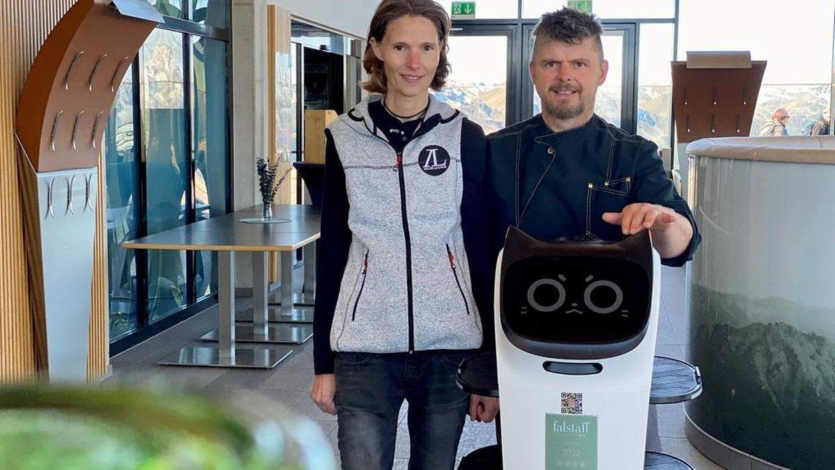 Claudia Stausberg (45) und Werner Rainer (49), Pächter der Adler Lounge in Kals am Großgklockner, mit ihrem Roboter Charly