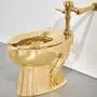 Sotheby’s has announced it will auction a solid gold toilet, a sculpture by Italian artist Maurizio Cattelan called “America.” The auction is set for Nov. 18 in New York. (Sotheby via AP)