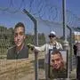Varda Ben Baruch, holding a picture of her grandson Edan Alexander who is held hostage in Gaza, gathers with other families to call out on loudspeakers in hopes that their loved ones will hear them, near the Gaza border in Kibbutz Nir Oz, southern Israel, Sunday, April 20, 2025. (AP Photo/Ohad Zwigenberg )