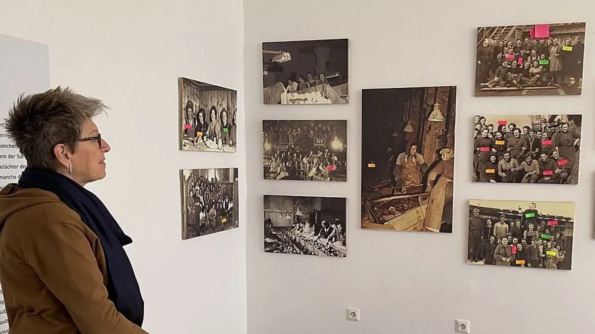 Christa Kolb vor den "Suchbildern" der Ausstellung, wo die Namen von Klauberfrauen dazugeklebt werden können