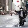 A man wearing a mask tries to catch a taxi at Times Square amid the Covid-19 pandemic on April 30, 2020 in New York City. (Photo by Johannes EISELE / AFP)