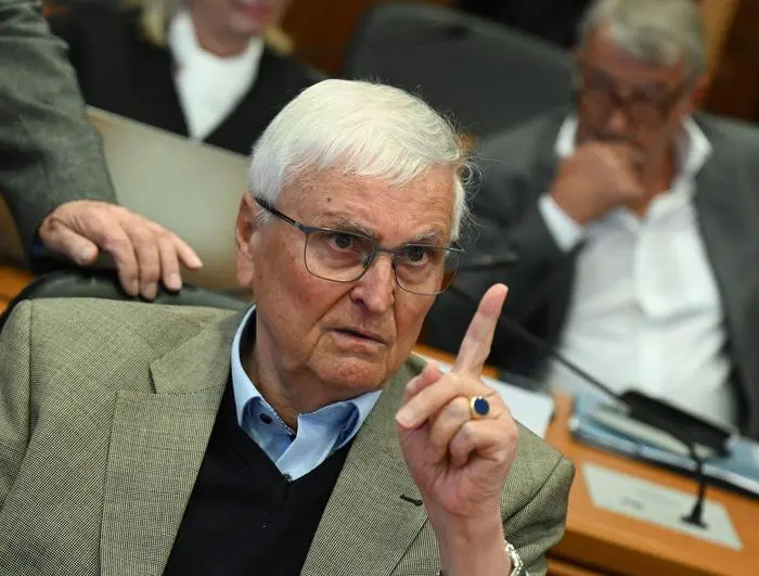 Former Presidents of Germany's Football Federation (Deutscher Fussball Bund, DFB) Theo Zwanziger (foreground) and Wolfgang Niersbach (R) wait for the continuation of a trial for tax fraud amounting to 13.7 million euros for the benefit of the DFB in connection with the 2006 World Cup hosted by Germany, in Frankfurt am Main, western Germany, April 15, 2024. (Photo by Arne Dedert / POOL / AFP)