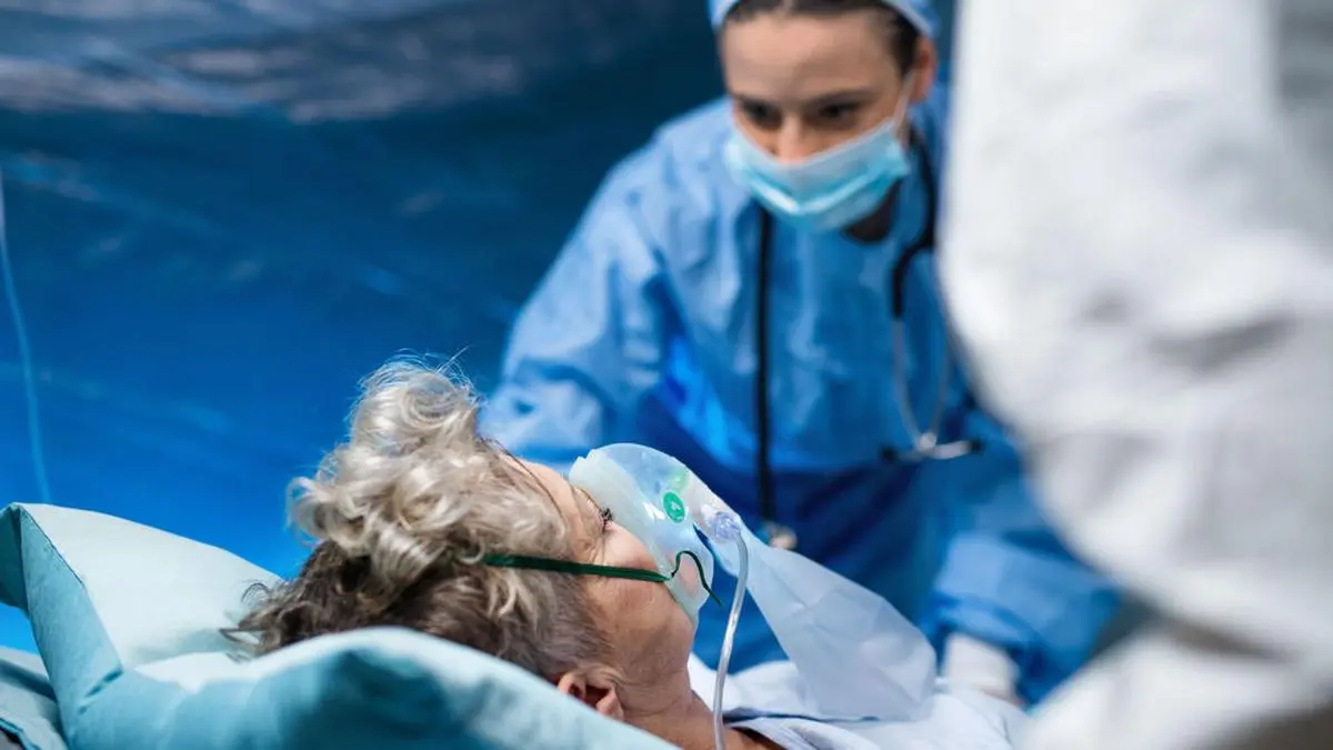 An infected patient in quarantine lying in bed in hospital, coronavirus concept.