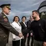 Ukraine's President Volodymyr Zelensky (R) is welcomed by a Ukranian military personnel and Ukraine's Ambassador to Switzerland Iryna Wenediktowa (C) as he arrives at the Zurich airport on June 14, 2024, ahead of the Ukraine Peace Summit in Switzerland. World leaders from countries around the world will gather in the luxury Burgenstock resort, central Switzerland this weekend to try to work out a way towards a peace process for Ukraine -- albeit without Russia. (Photo by MICHAEL BUHOLZER / POOL / AFP)