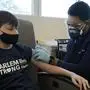 Jessie Pollock, 14, receives his first Pfizer COVID-19 vaccination at NYC Health + Hospitals/Harlem, from nurse Steven Russell, in New York, Thursday, May 13, 2021. New York Gov. Andrew Cuomo announced Wednesday that children between the ages of 12 and 15 can get vaccinated in New York effective immediately. (AP Photo/Richard Drew)