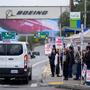 Boeing workers greet other union members in a support van as they strike after voting to reject a contract offer Sunday, Sept. 15, 2024, near the company's factory in Everett, Wash. (AP Photo/Lindsey Wasson)