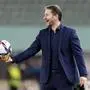 Austria's head coach Franco Foda holds a ball during the international friendly soccer match between Austria and Scotland at the Ernst Happel Stadion in Vienna, Austria, Tuesday, March 29, 2022. (AP Photo/Florian Schroetter)