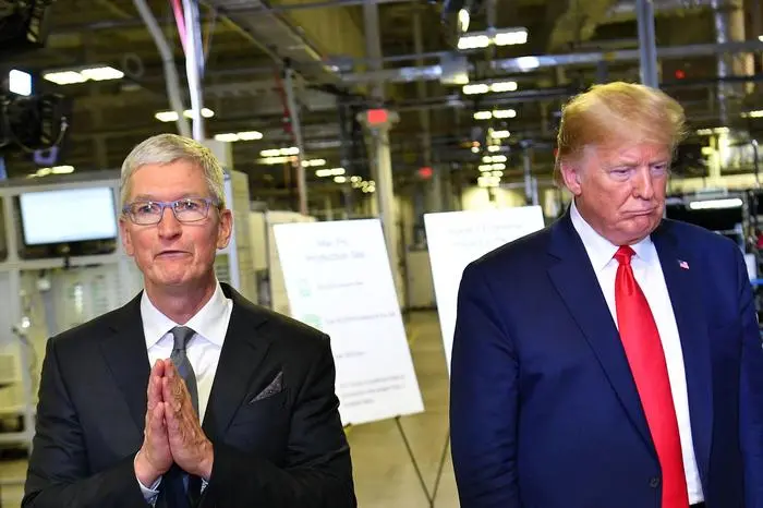 (FILES) US President Donald Trump (R) and Apple CEO Tim Cook speak to the press during a tour of the Flextronics computer manufacturing facility where Apple's Mac Pros are assembled in Austin, Texas, on November 20, 2019. US President Donald Trump ratcheted up the US trade war on May 23, 2025, threatening to impose a new 25 percent levy against Apple, and a 50 percent tariff on the European Union. The president said Apple had failed to move iPhone production to the United States despite his repeated requests, and he threatened new duties of 