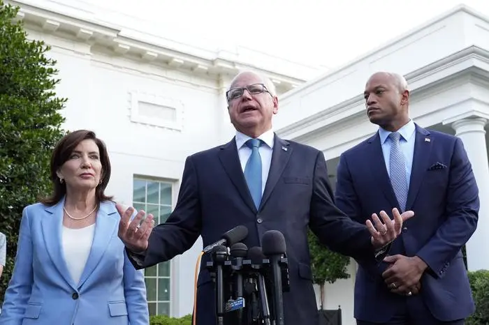 Minnesota Gov. Tim Walz, center, standing with New York Gov. Kathy Hochul, left, and Maryland Gov. Wes Moore, right, talks with reporters following their meeting with President Joe Biden at the White House in Washington, Wednesday, July 3, 2024. (AP Photo/Susan Walsh)