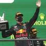 First place, Red Bull driver Max Verstappen of the Netherlands, holds up the trophy on the podium after the Formula One Grand Prix at the Spa-Francorchamps racetrack in Spa, Belgium, Sunday, Aug. 29, 2021. The race was red flagged due to weather conditions. (AP Photo/Francisco Seco)