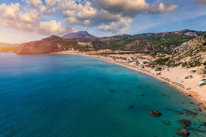 Tsampika beach with golden sand view from above, Rhodes, Greece. Aerial birds eye view of famous beach of Tsampika, Rhodes island, Dodecanese, Greece Model Released Property Released xkwx tsampika sandy beach rhodos rhodes dodecanes lindos umbrella beautiful mediterranean aerial greek dodecanese coastline mountain bay nature rodos island sand beach tourism coast summer vacation sea water travel greece tsambika panorama europe turquoise destination seascape lagoon sunny leisure aegean sun people sunlight sunbeds seaside relaxing from above drone photography vacations attraction emerald